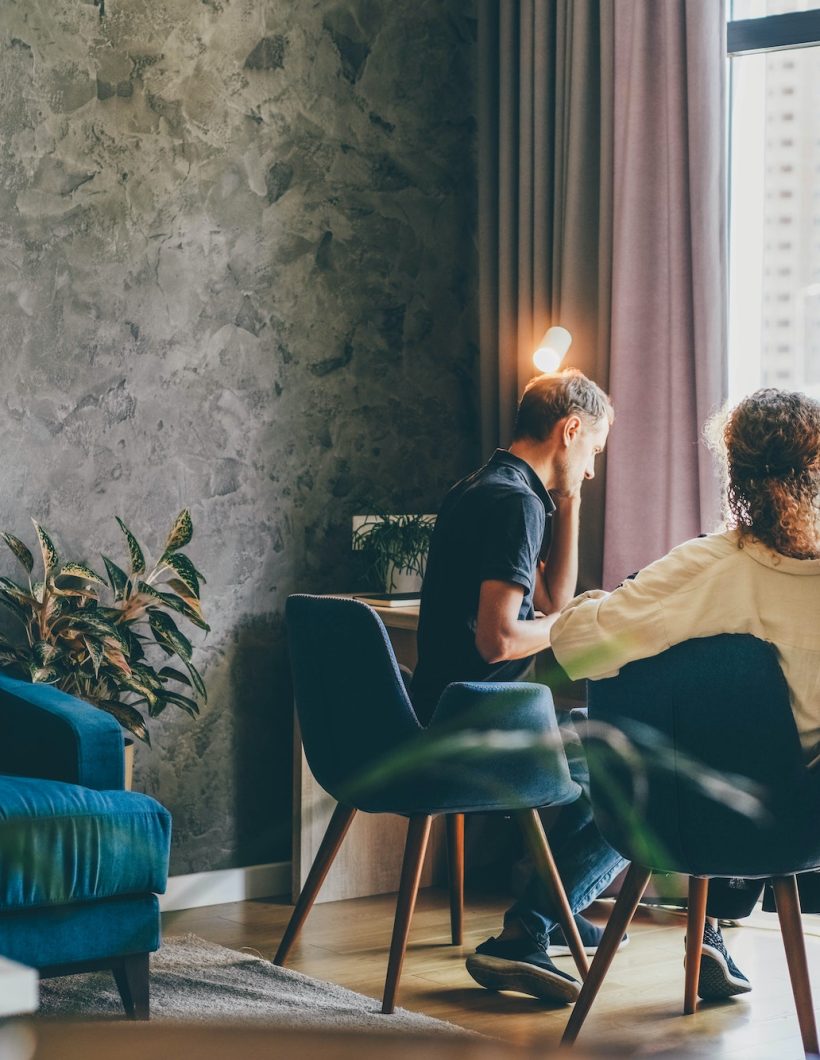 Family of middle aged man and woman at work together on project